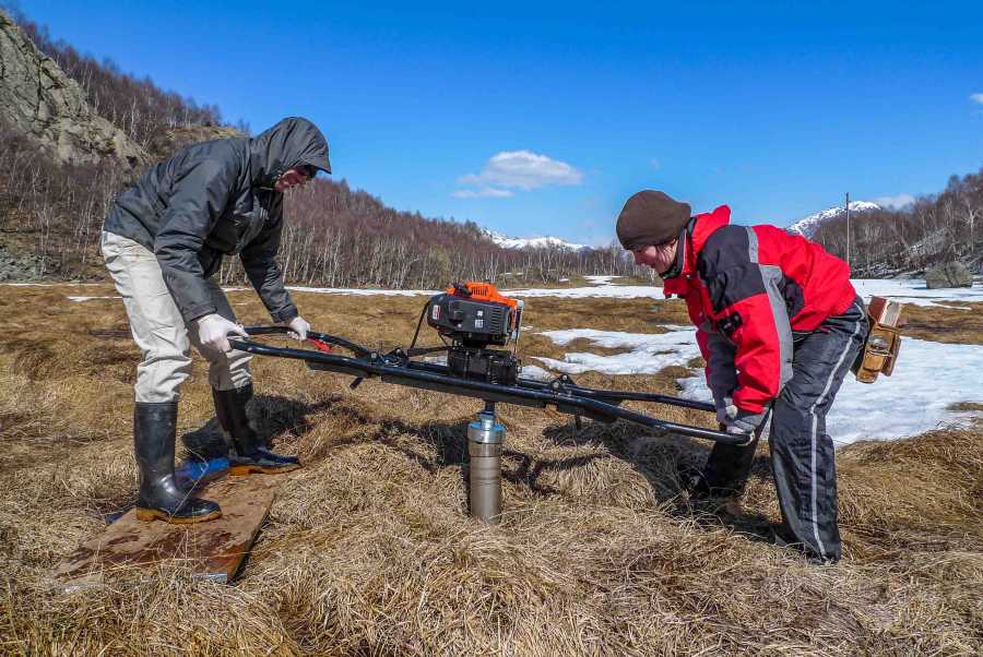 Enlarged view: PhD students collecting peat cores